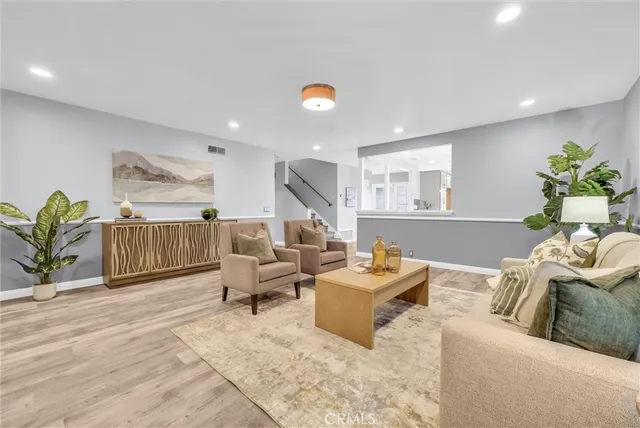 a living room with furniture and a potted plant