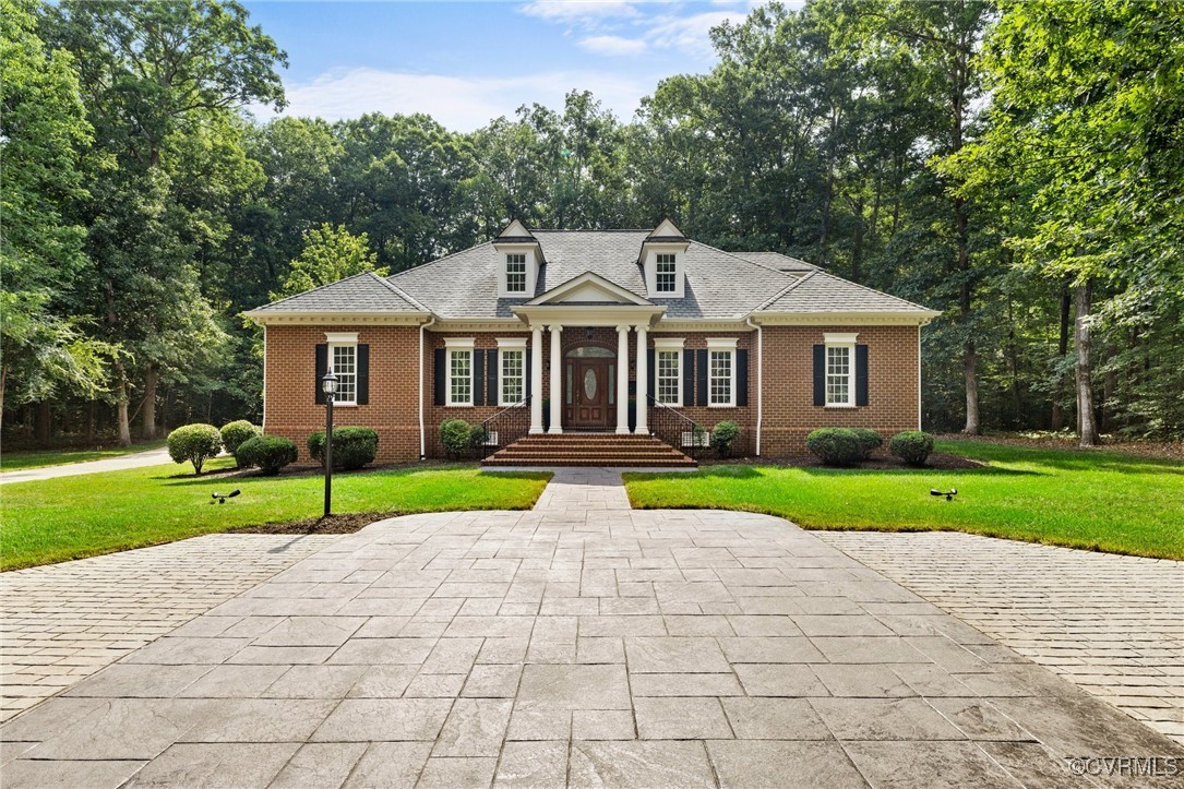 a view of house with a garden and pathway