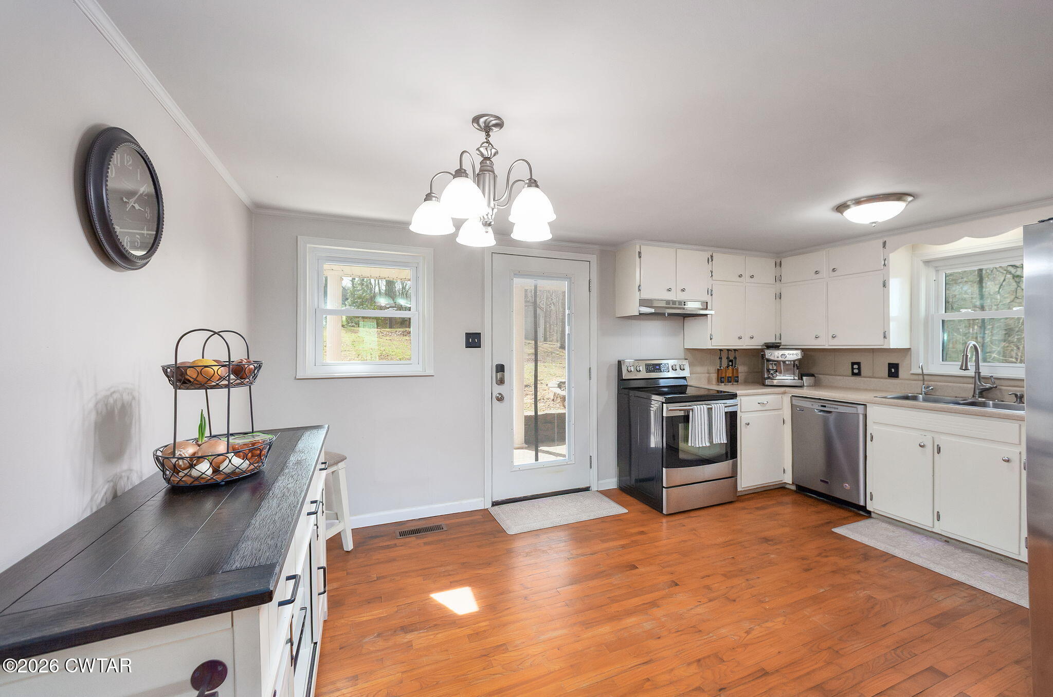 108 Springbrook Drive Jackson, TN 38305 - Photo 15 of 40 a kitchen with granite countertop a stove a sink dishwasher and a refrigerator with wooden floor