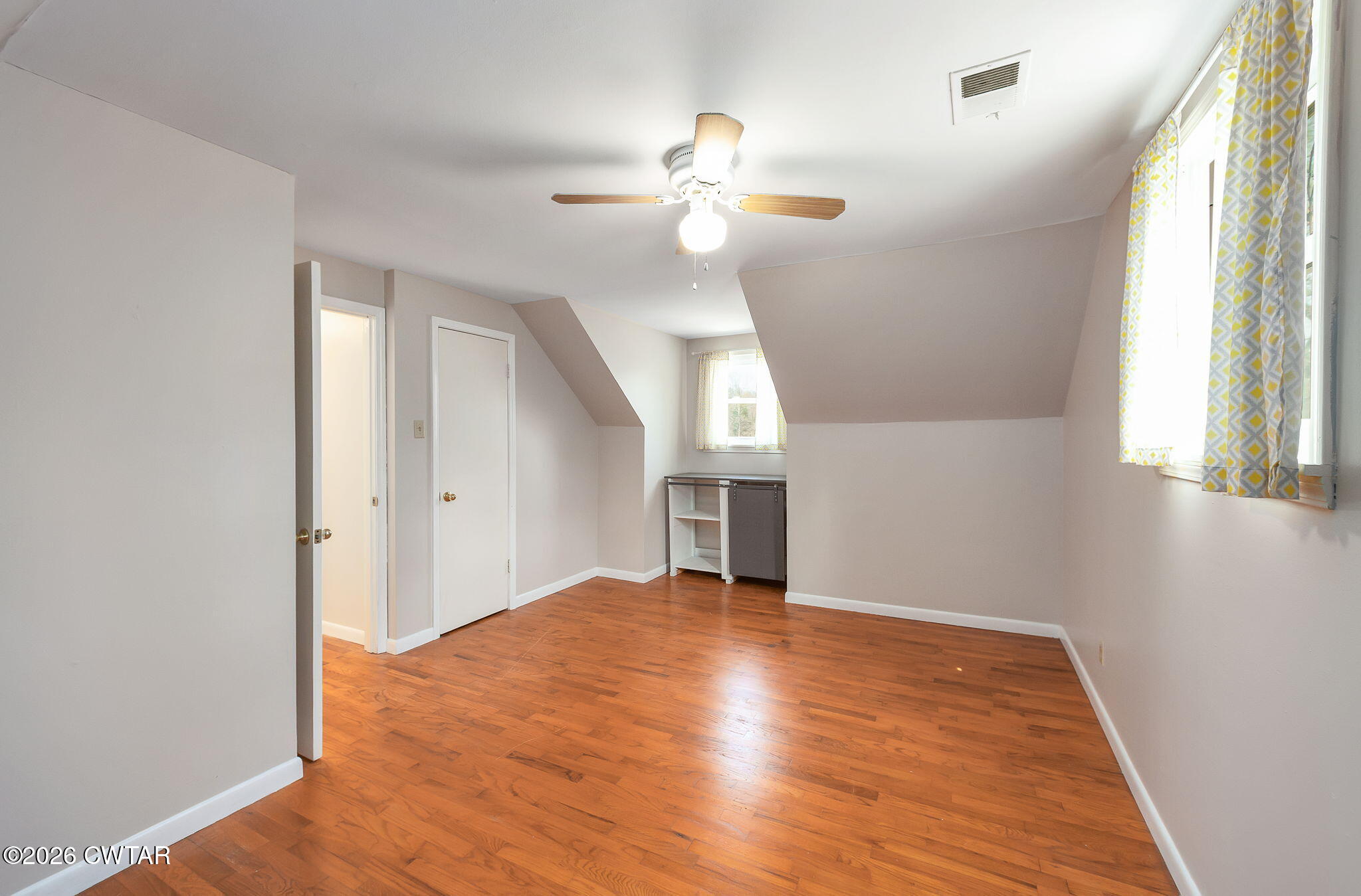 108 Springbrook Drive Jackson, TN 38305 - Photo 18 of 40 a view of empty room with wooden floor and fan