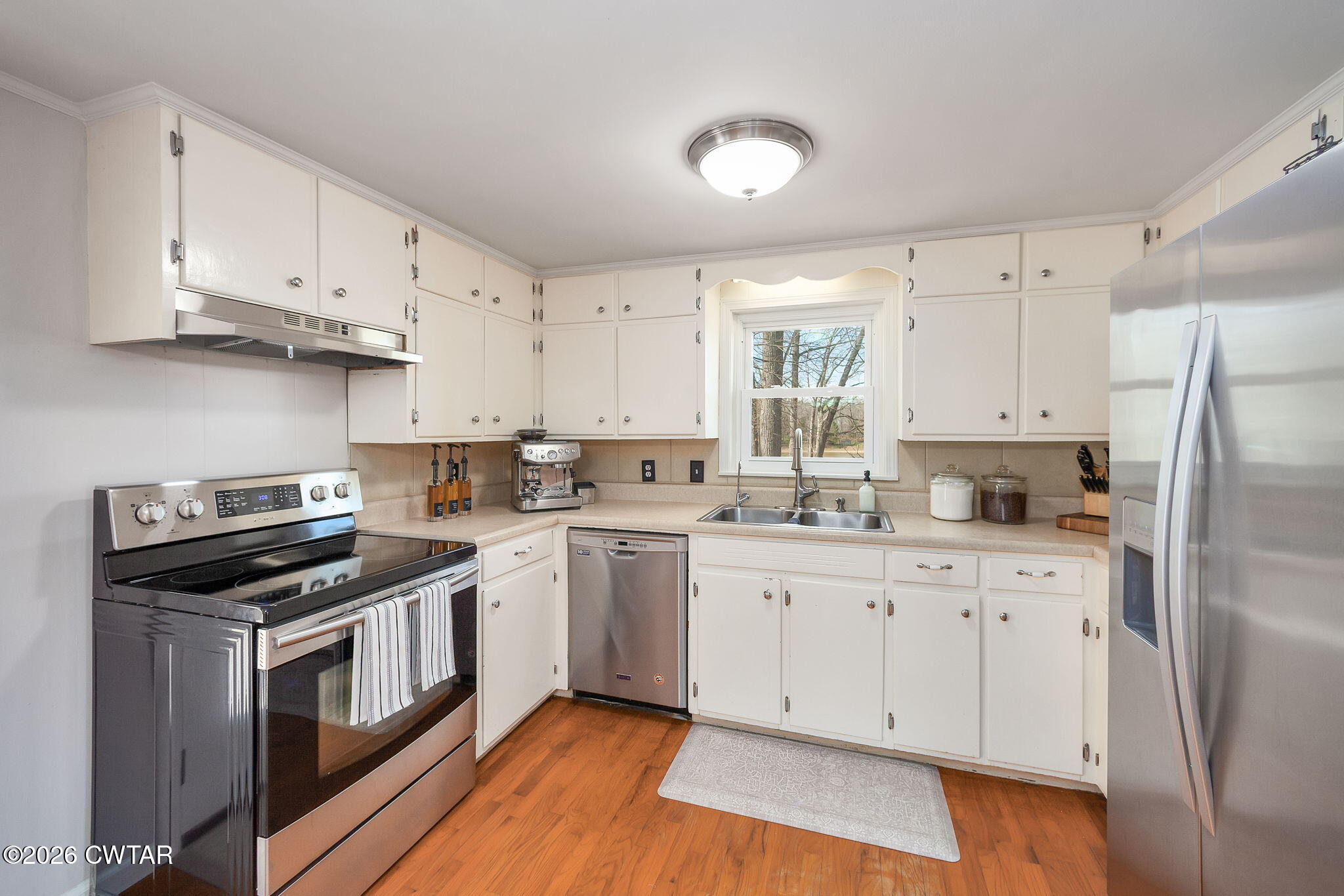 108 Springbrook Drive Jackson, TN 38305 - Photo 3 of 40 a kitchen with white cabinets and stainless steel appliances