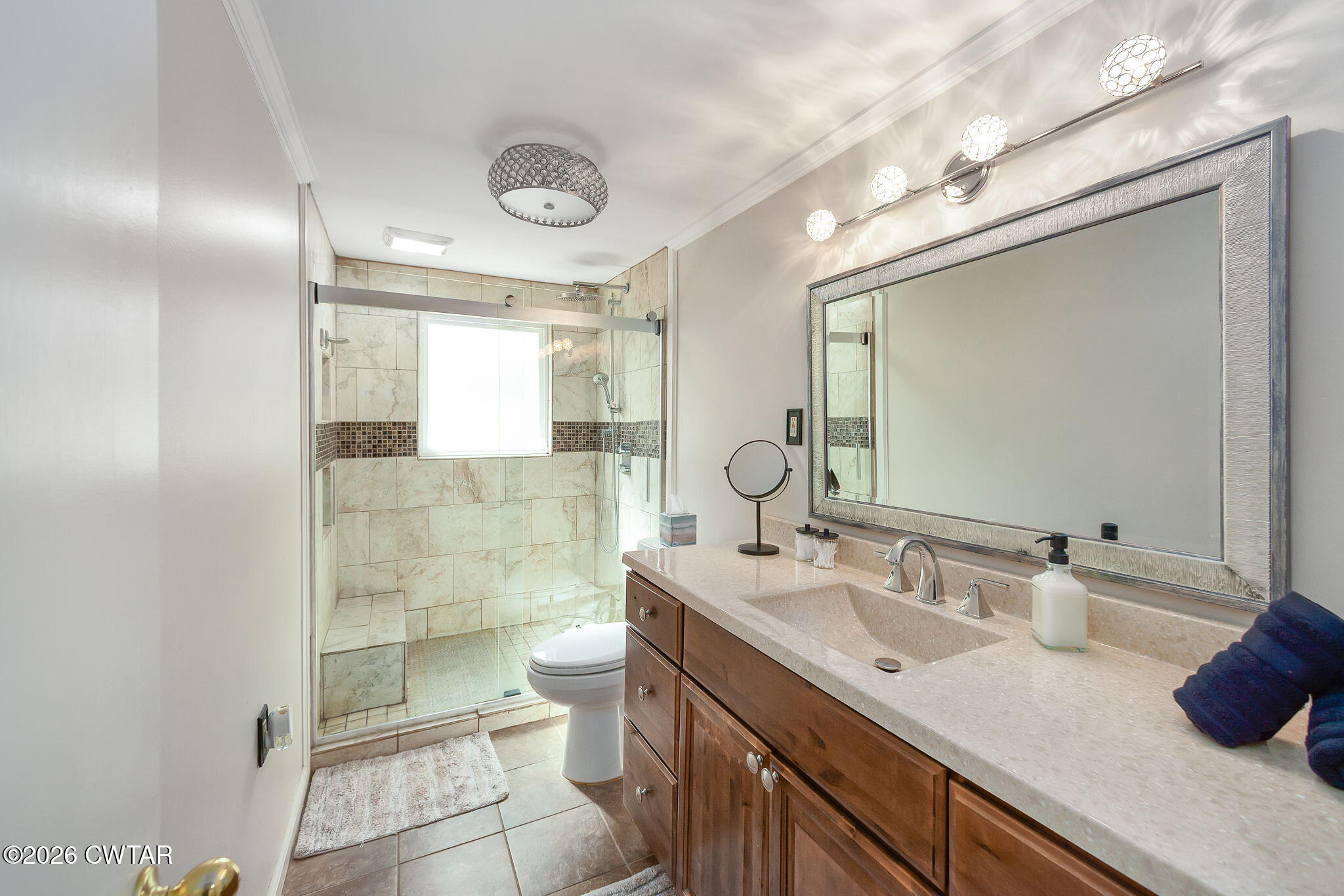 108 Springbrook Drive Jackson, TN 38305 - Photo 8 of 40 a bathroom with a granite countertop sink a toilet a mirror and vanity