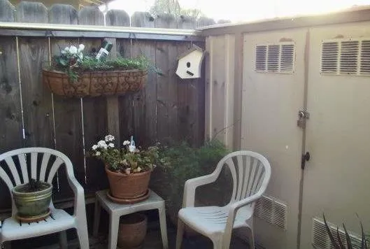 a view of a chair and table in back side of the house