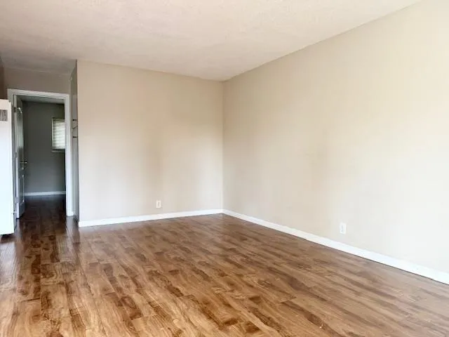 a view of an empty room and wooden floor