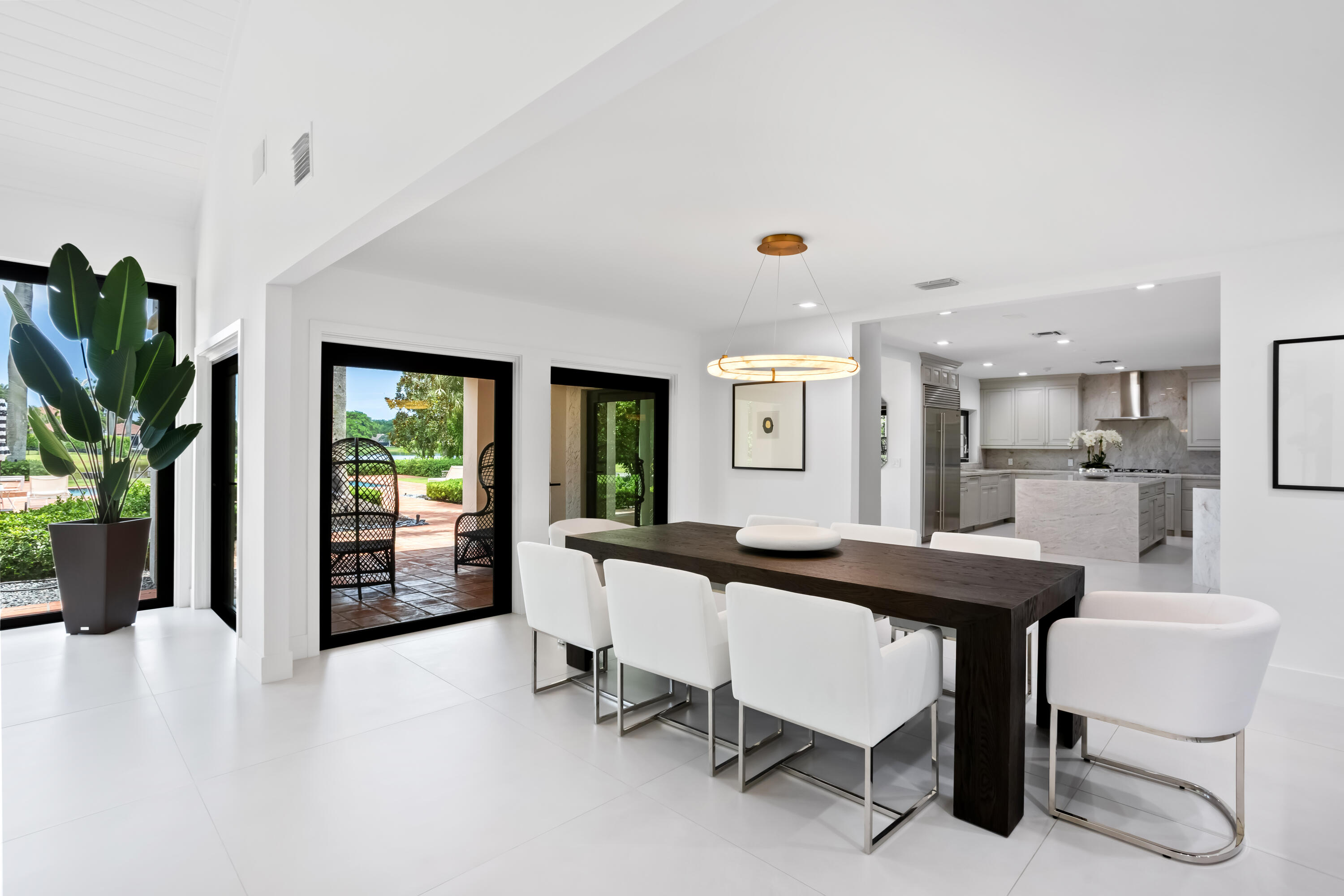18743 Long Lake Drive Boca Raton, FL 33496 - Photo 16 of 84 a dining room with furniture and a floor to ceiling window
