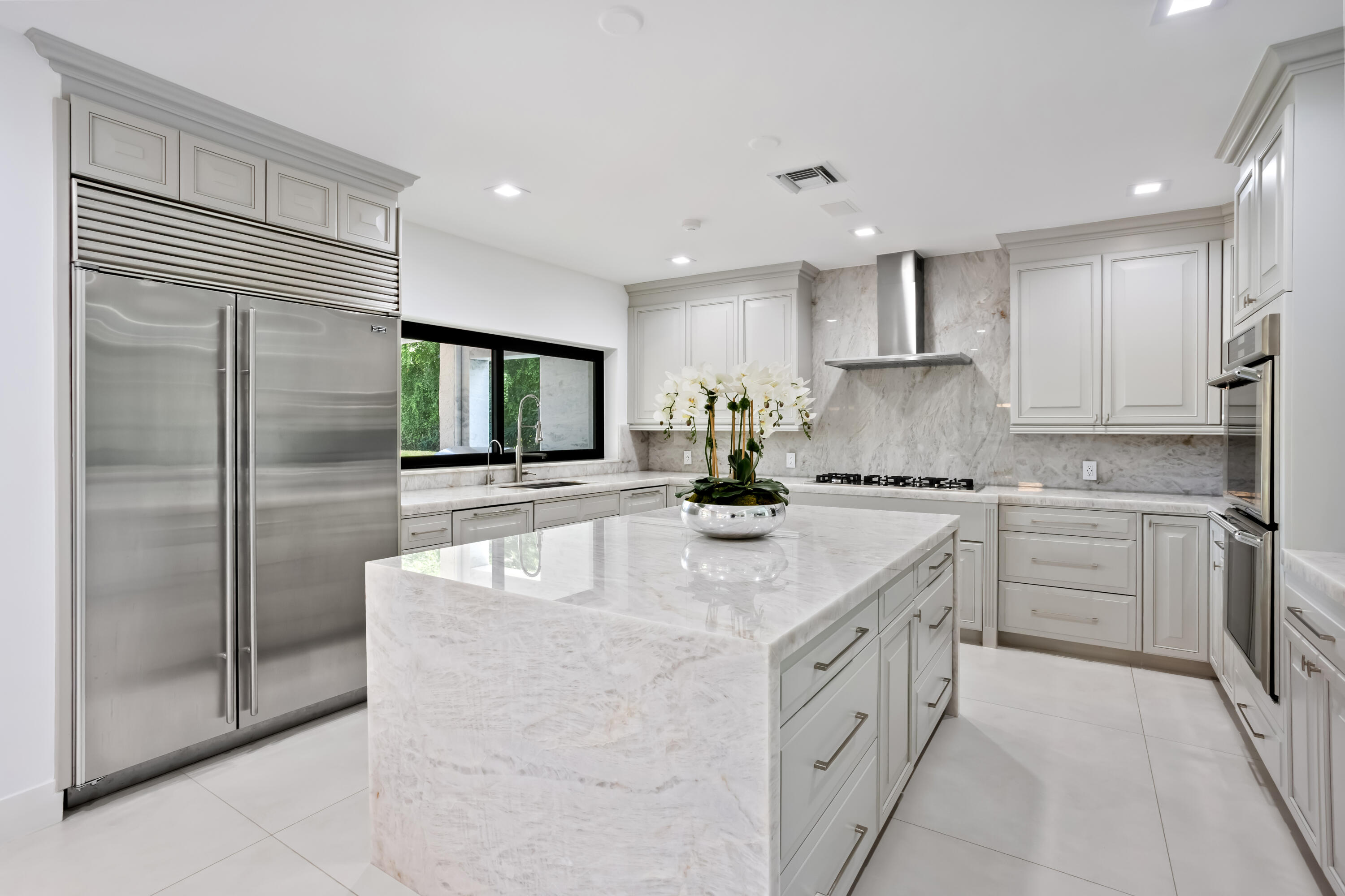 18743 Long Lake Drive Boca Raton, FL 33496 - Photo 19 of 84 a kitchen with stainless steel appliances granite countertop a sink a stove and a refrigerator