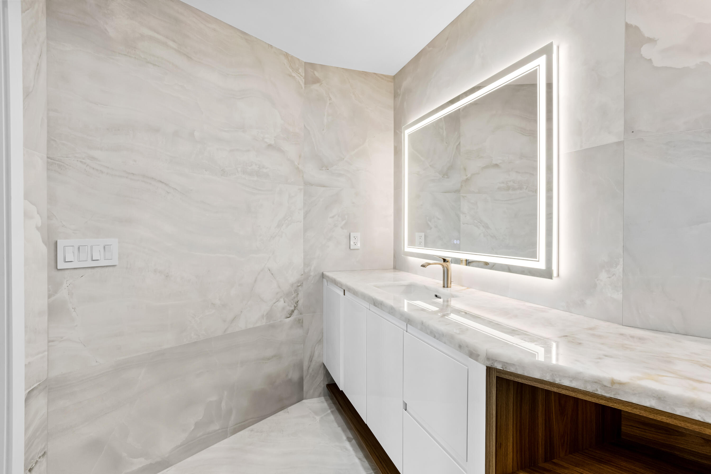 18743 Long Lake Drive Boca Raton, FL 33496 - Photo 35 of 84 a bathroom with a granite countertop sink a mirror and a shower