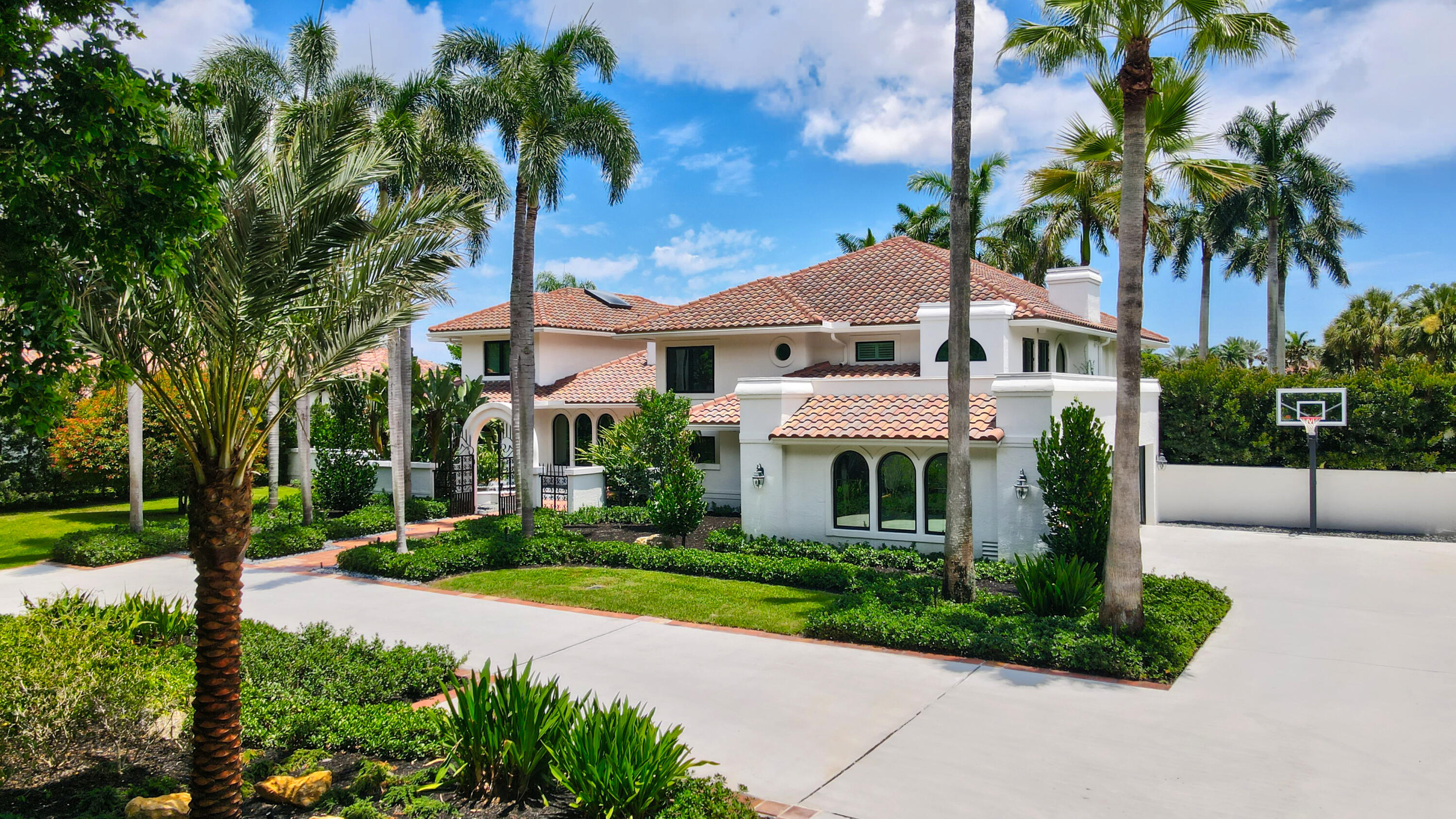 18743 Long Lake Drive Boca Raton, FL 33496 - Photo 5 of 84 a front view of a house with a yard and potted plants