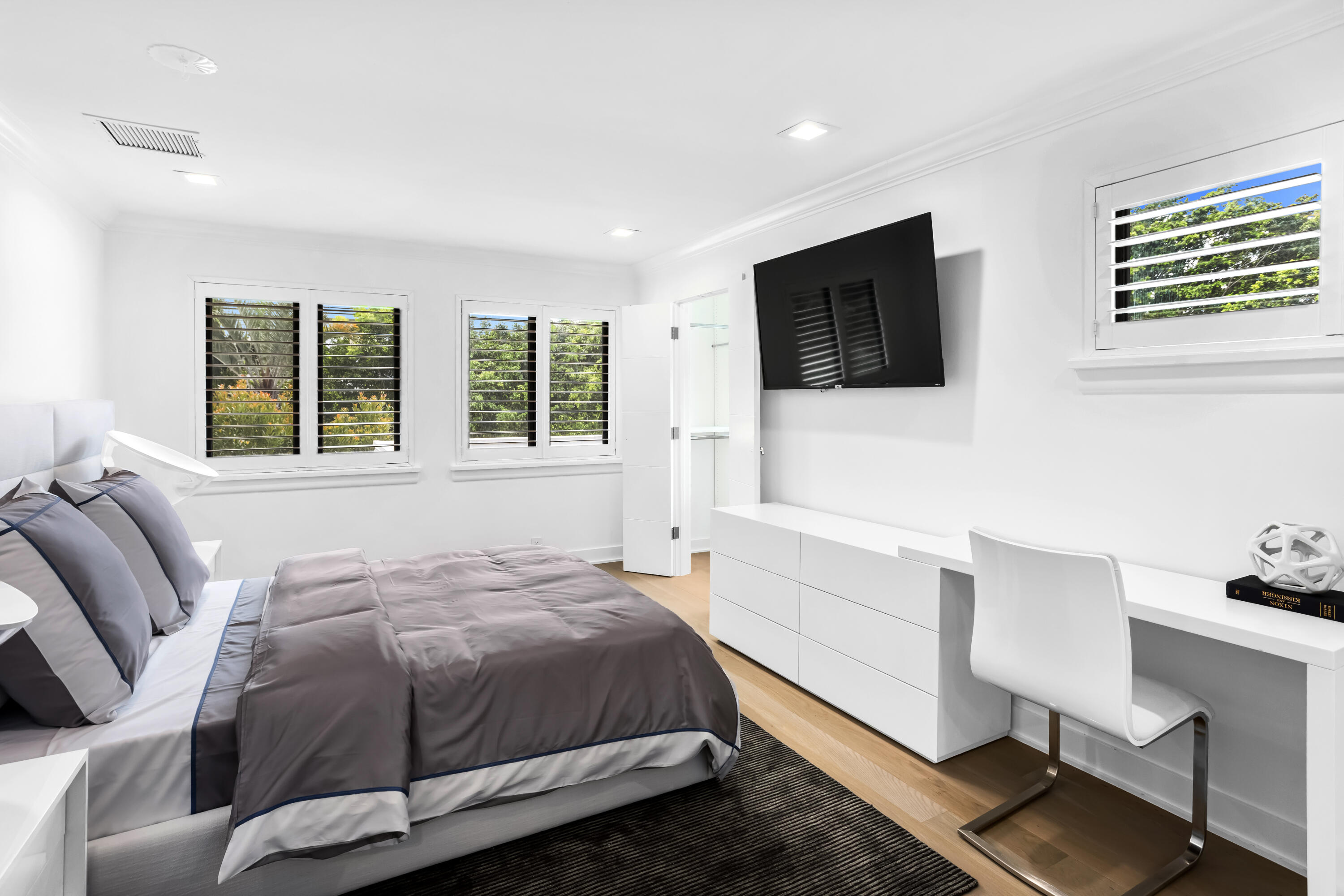 18743 Long Lake Drive Boca Raton, FL 33496 - Photo 55 of 84 a bedroom with a bed a flat screen tv and windows