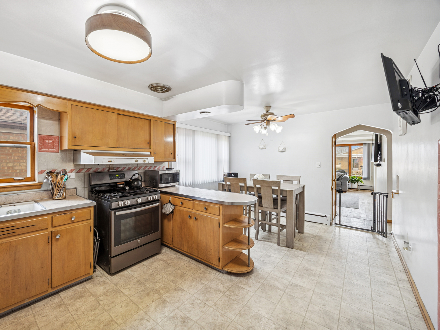 3905 West 68th Place Chicago, IL 60629 - Photo 8 of 27 a kitchen with stove a sink and chairs