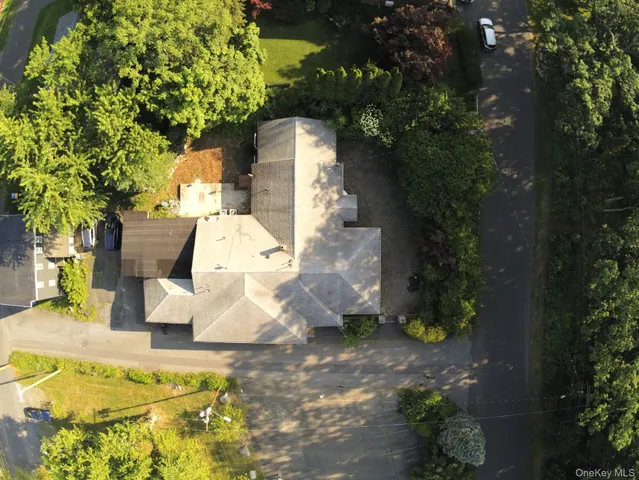 an aerial view of residential house with parking space and trees