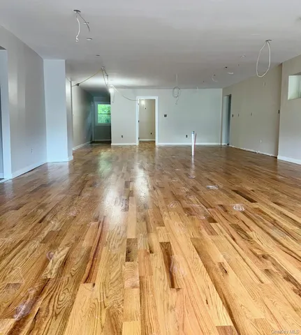 a view of a room with wooden floor