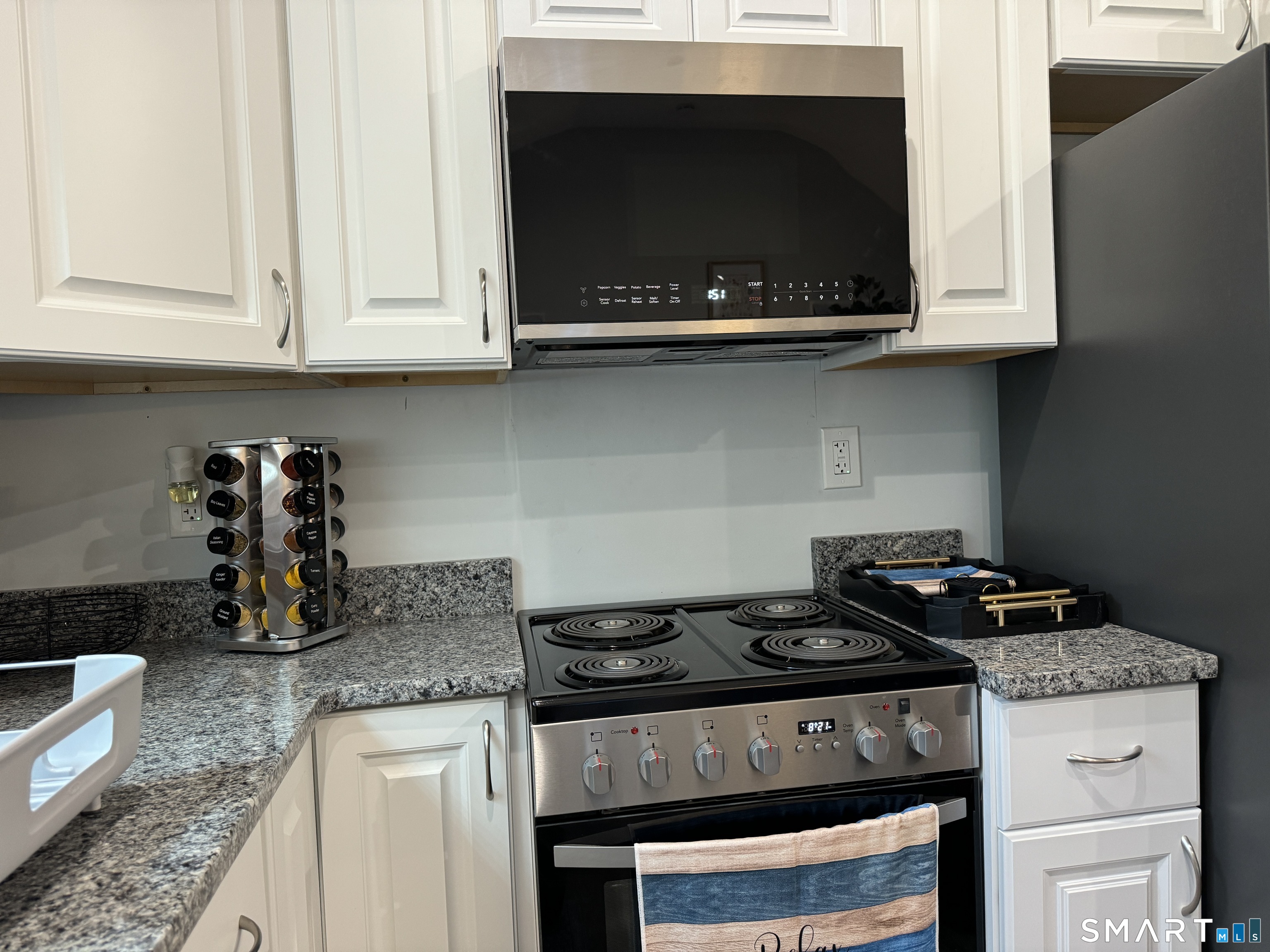 7 Pootatuck Park Road Newtown, CT 06482 - Photo 6 of 25 a kitchen with granite countertop stainless steel appliances a stove and a microwave