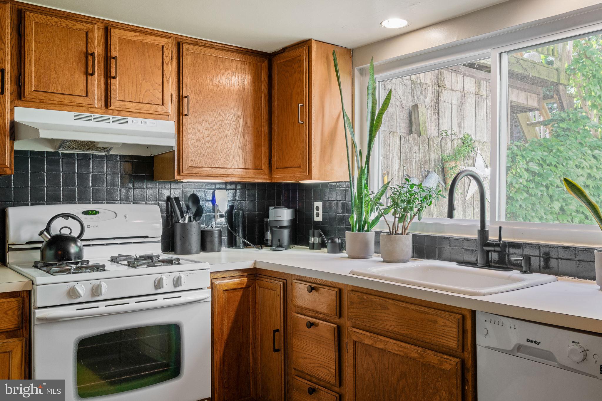 142 Carpenter Street Philadelphia, PA 19147 - Photo 14 of 49 a kitchen with a stove a sink and a refrigerator