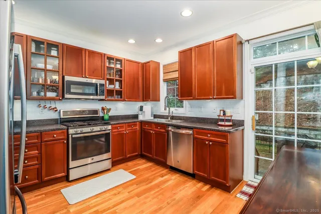 a kitchen with stainless steel appliances granite countertop a refrigerator and a sink