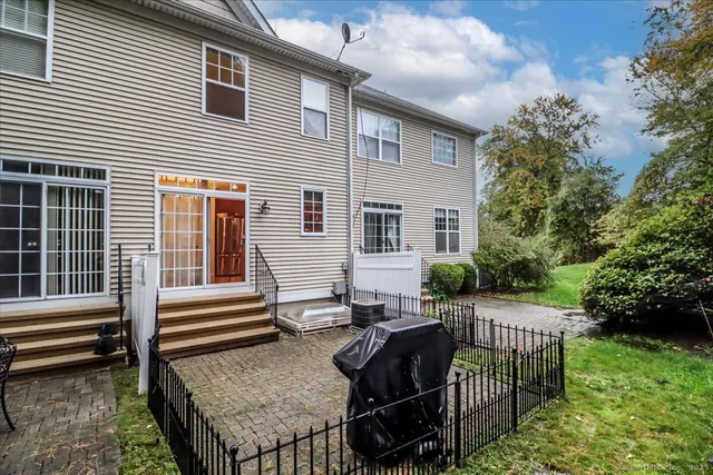 a view of a house with backyard and sitting area