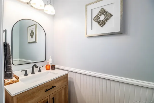 a room with a sink and a mirror