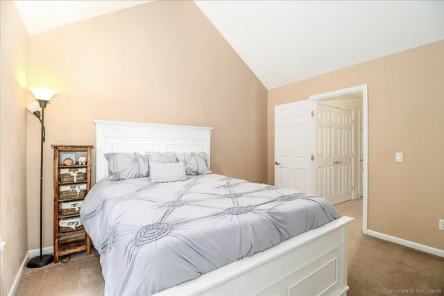 a bedroom with a bed and a night stand