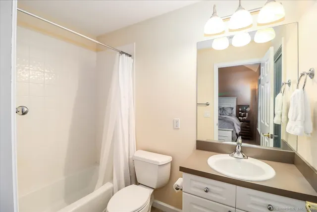 a bathroom with a sink toilet a mirror and shower