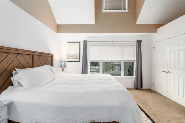 a bedroom with a large bed and a large window