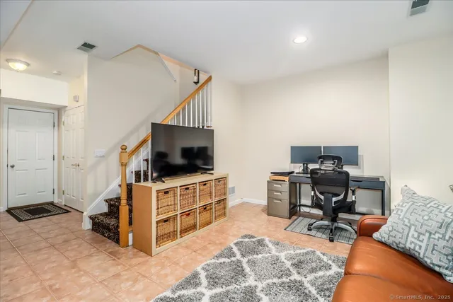 a view of a livingroom with workspace and a couch