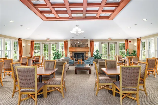 a dining room with furniture a chandelier and wooden floor