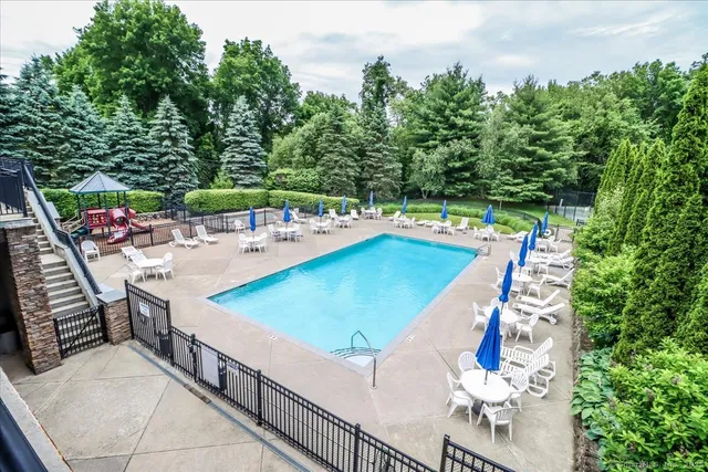 swimming pool view with a seating space