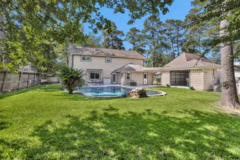 a front view of house with yard and green space
