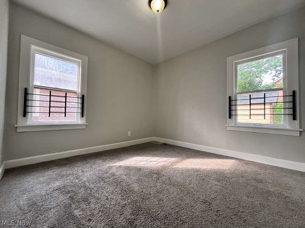 907 Rondel Road Cleveland, OH 44110 - Photo 8 of 26 Spacious room featuring neutral grey walls and new grey carpeting