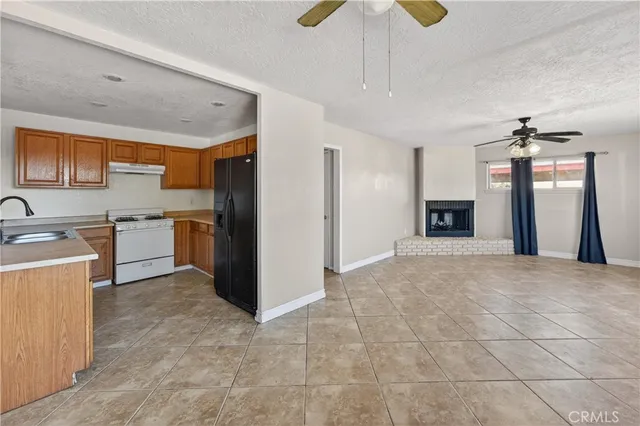 a view of a kitchen with a sink and a refrigerator