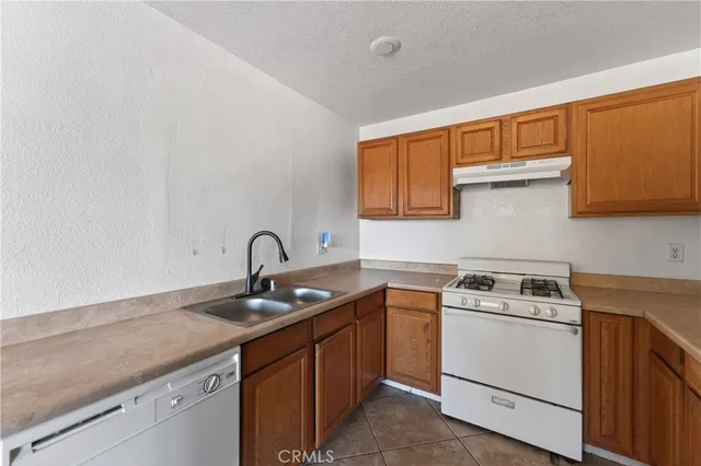 a view of a kitchen with sink and cabinets