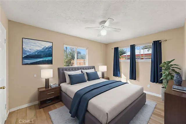 a bedroom with a large bed and a chandelier