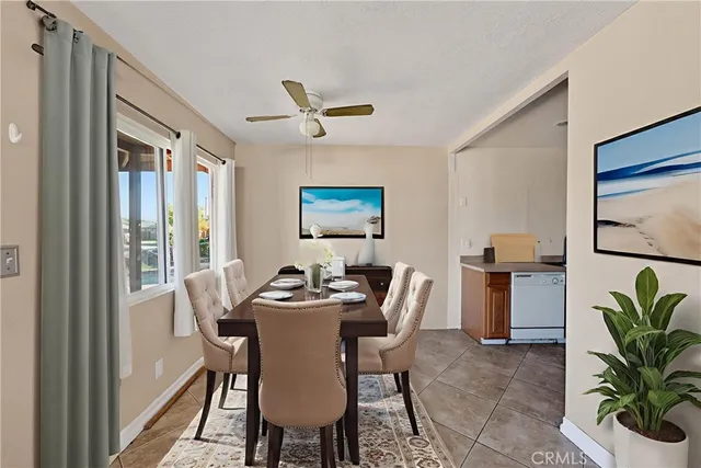 a dining room with furniture potted plants and wooden floor