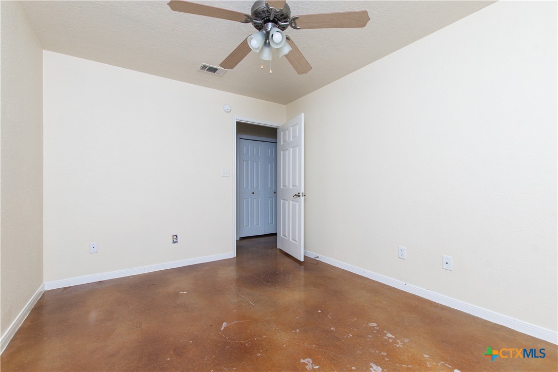 211 West Arlo Road, Unit A Harker Heights, TX 76548 - Photo 14 of 19 an empty room with a ceiling fan and carpet