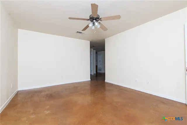 a view of a room with a ceiling fan