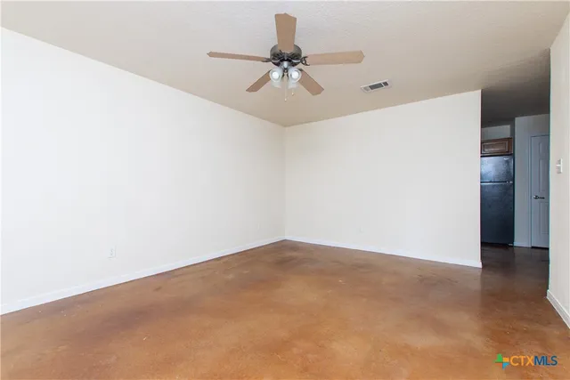 a view of a room with a ceiling fan