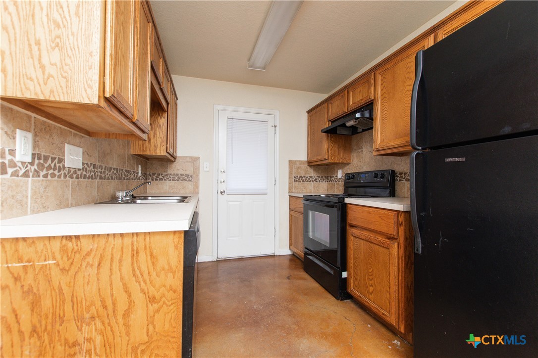 211 West Arlo Road, Unit A Harker Heights, TX 76548 - Photo 5 of 19 a kitchen with stainless steel appliances granite countertop a refrigerator a stove and a sink with wooden floor