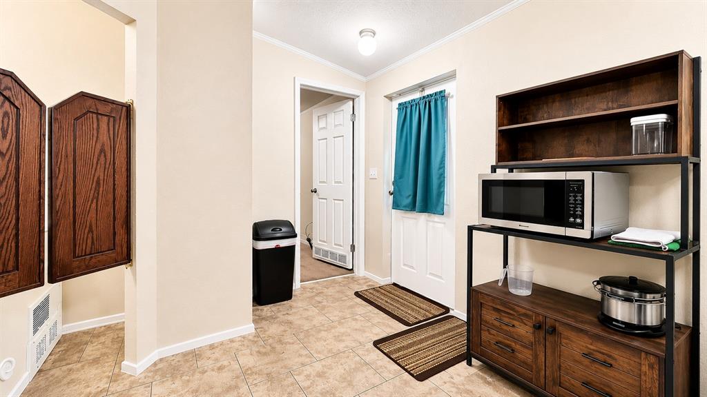 741 Waterfront Row Quitman, TX 75783 - Photo 15 of 40 a hallway with television and stainless steel appliances