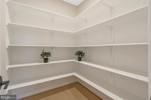 a open dining room with stainless steel appliances granite countertop a table chairs and a refrigerator