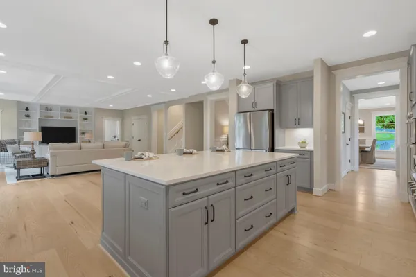 a kitchen with stainless steel appliances kitchen island granite countertop a stove a sink and a refrigerator