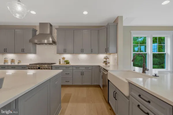 a kitchen with stainless steel appliances granite countertop a sink counter space cabinets and a large window