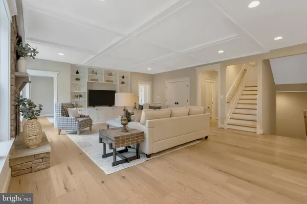 a spacious bedroom with a window and a chair