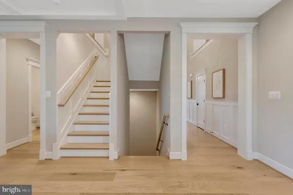 a view of a hallway with windows and stairs