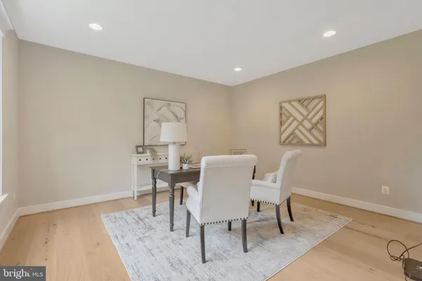 a view of a hallway with wooden floor and windows