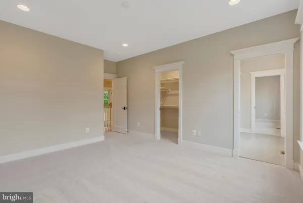 a spacious bedroom with a bed and a flat screen television