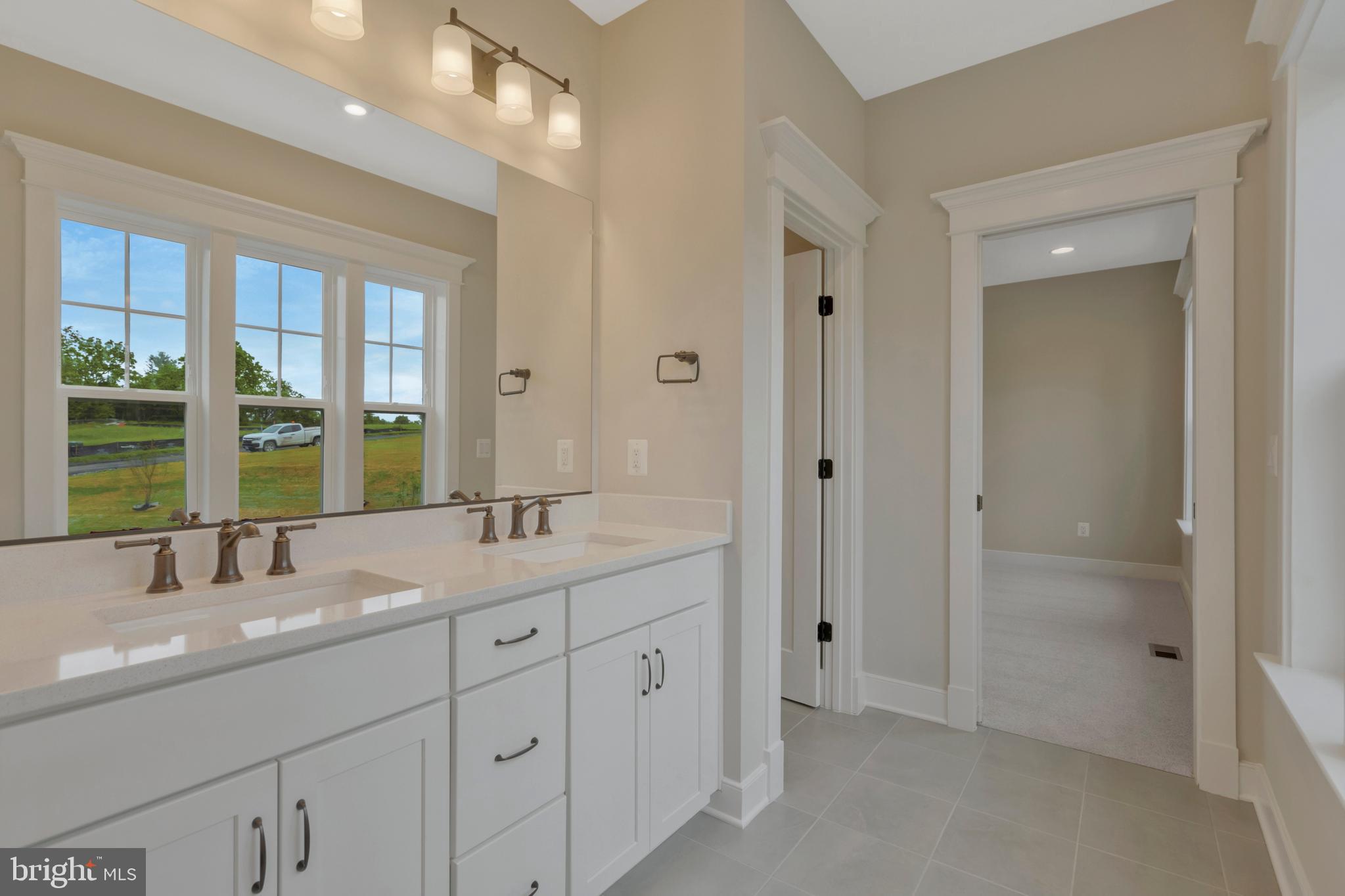 16020 Keymer Hl Court Hamilton, VA 20158 - Photo 51 of 69 a bathroom with a sink double vanity and a large mirror