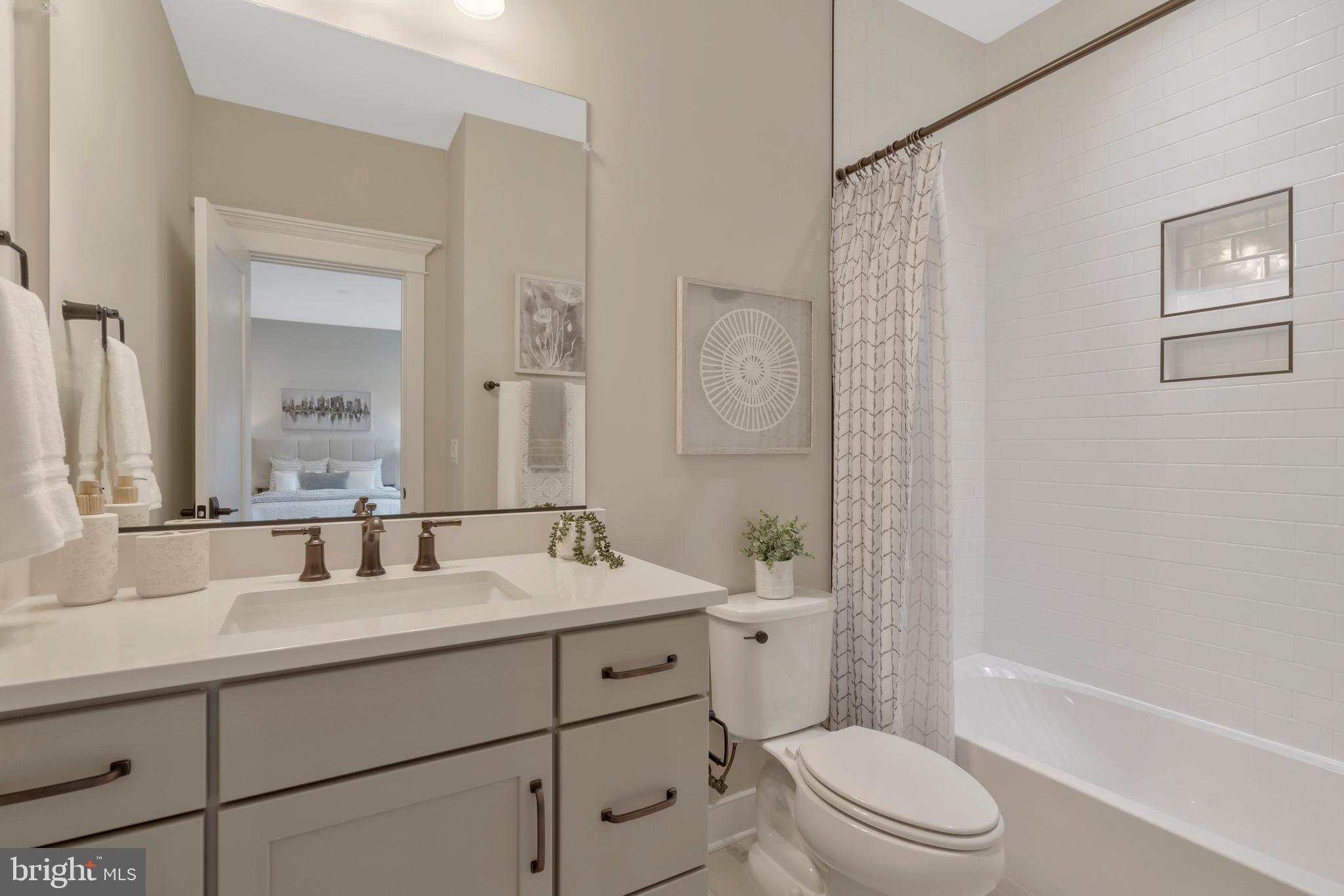 16020 Keymer Hl Court Hamilton, VA 20158 - Photo 59 of 69 a bathroom with a toilet a sink a mirror a bathtub and shower