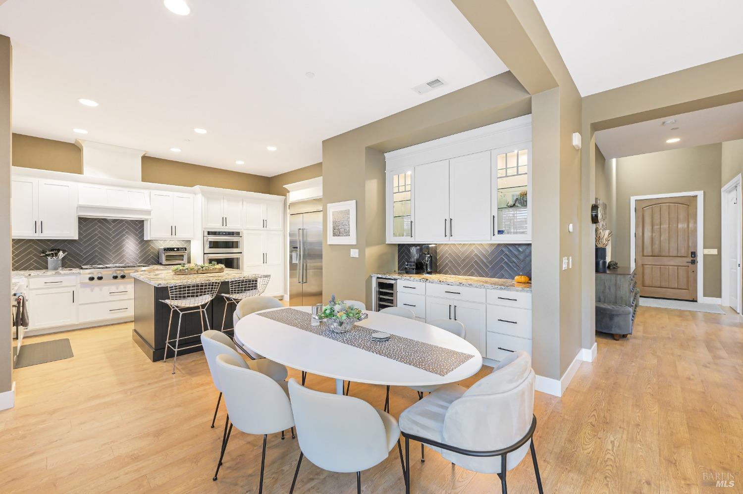 46 Audubon Way Novato, CA 94949 - Photo 12 of 31 a large kitchen with kitchen island a dining table and chairs