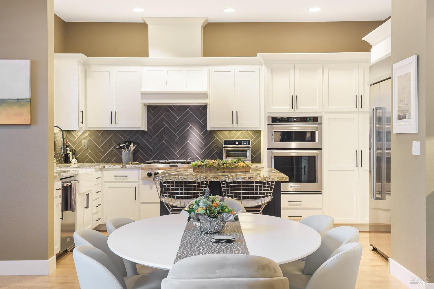 46 Audubon Way Novato, CA 94949 - Photo 15 of 31 a kitchen with stainless steel appliances a dining table chairs and a refrigerator