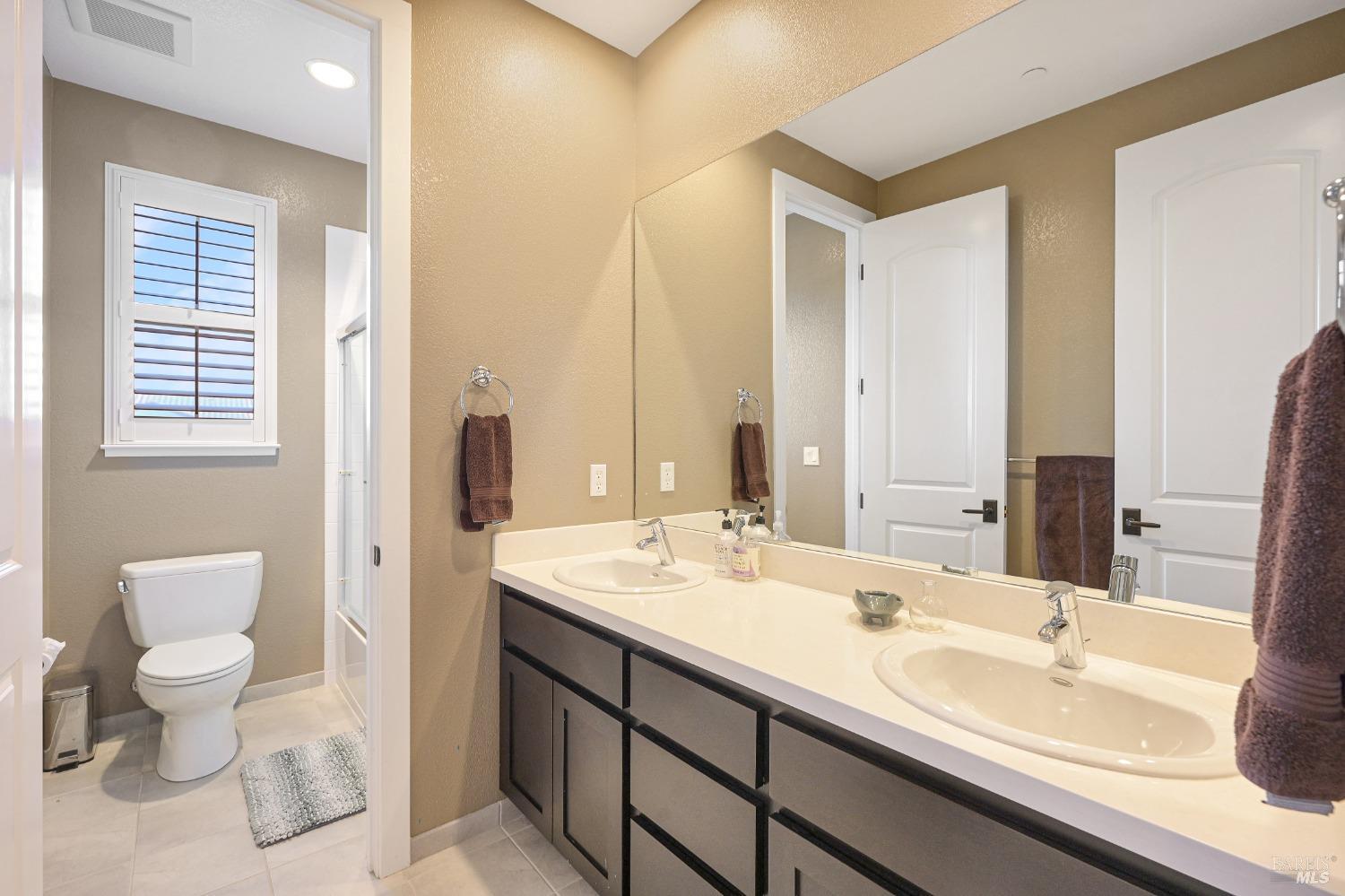 46 Audubon Way Novato, CA 94949 - Photo 16 of 31 a bathroom with a double vanity sink toilet and a mirror